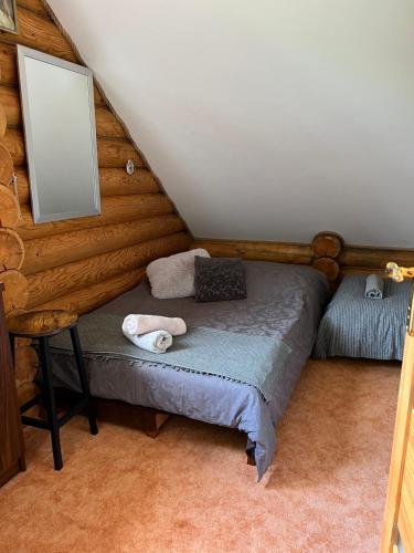 a bedroom with a bed with a laptop on it at Ranczo Borówka in Łapanów