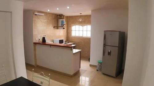 a kitchen with a counter and a refrigerator at Atalaya in Salta