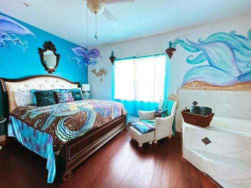 a bedroom with a bed with a mermaid painting on the wall at Inn on the Avenue in New Smyrna Beach