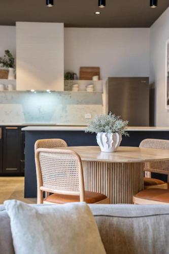 a kitchen with a table and chairs and a counter at Laneway Retreat in Grange