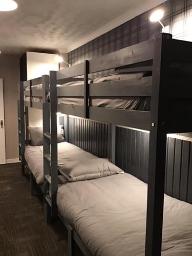 a group of bunk beds in a room at Highlander Hostel in Kyle of Lochalsh