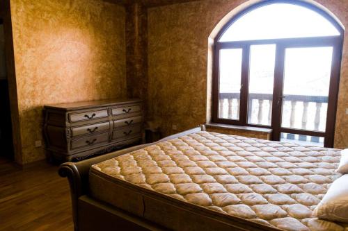 a bedroom with a bed and a window and a dresser at One-of-a-kind Home with a Million Dollar View in Yerevan