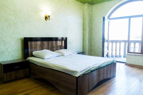a large bed in a room with a large window at One-of-a-kind Home with a Million Dollar View in Yerevan