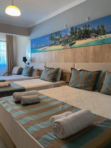 a large room with two beds and a couch at Akkan Beach Hotel in Bodrum City