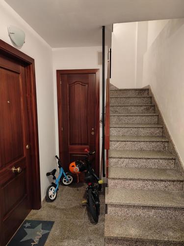 a scooter is parked next to a stairway at Apartamento Paseo Fluvial in Tui