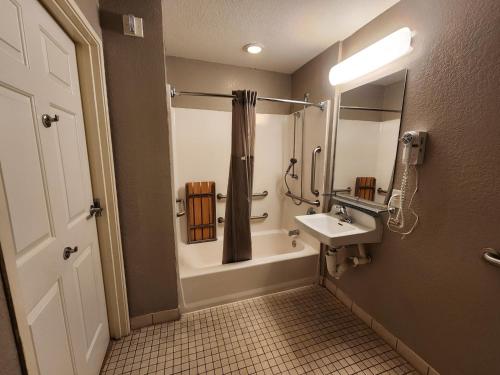a bathroom with a sink and a tub and a shower at Motel 6-Biloxi, MS - Beach in Biloxi