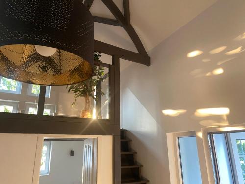 a chandelier in a room with a stair case at Scheunentraum Brenig in Bornheim