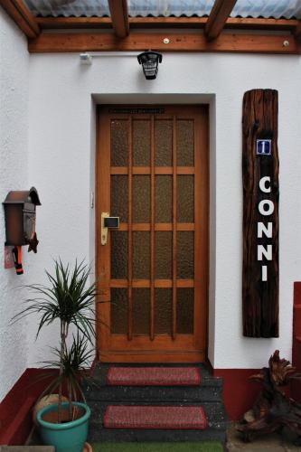 a front door of a house with a sign on it at Ferienwohnung CONNI in Hellenthal