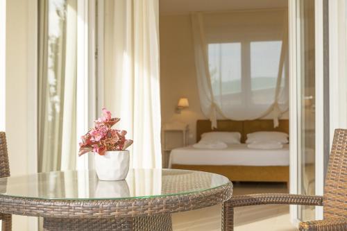 a table with a vase of flowers on top of a room at Sunny Hill in Sani Beach