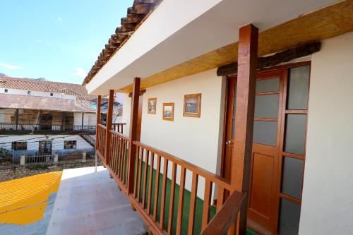 a balcony of a house with a wooden door at Central Plaza Apartments in Cusco