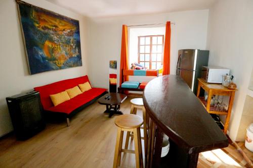 a living room with a red couch and a red table at Central Plaza Apartments in Cusco