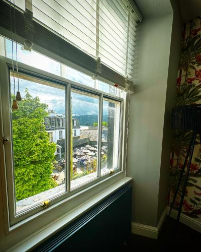 a window in a room with a view of a building at 1 West End Boutique Apartment in Bowness-on-Windermere