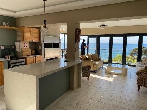 a kitchen and living room with a view of the ocean at Umdloti Villa in Umdloti