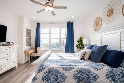 a bedroom with a bed and a ceiling fan at 5 Star Luxury Beach Condo-Anchor Oasis in St Pete Beach