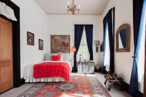 a bedroom with a bed and a red blanket at Beard and Lady Inn in Chester