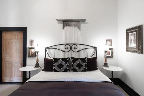 a bedroom with a black bed with two tables at Beard and Lady Inn in Chester