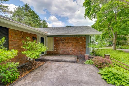 a brick house with a patio in front of it at Spacious Rochester Home with Heated Pool and Hot Tub! in Rochester