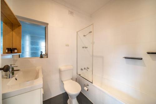een badkamer met een toilet, een wastafel en een douche bij That 70s Cottage Parkside Cottage Backyard WiFi in Unley