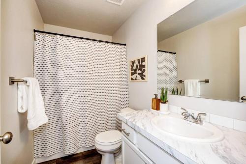 a bathroom with a sink and a toilet and a shower at BRAND NEW 4-BDRM HOME Farmhouse at Grand Rapids in Meridian