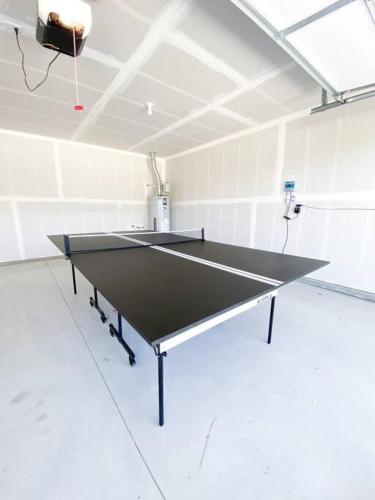 a ping pong table in a white room with at BRAND NEW 4-BDRM HOME Farmhouse at Grand Rapids in Meridian