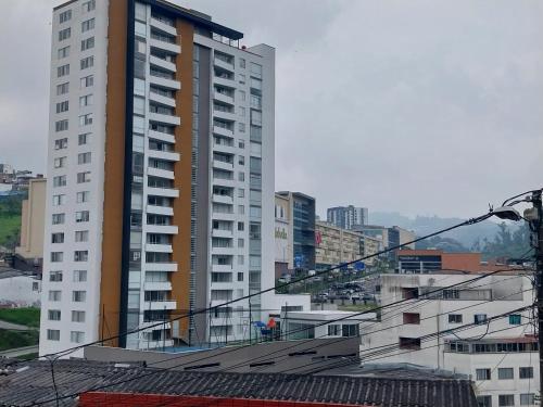 a large tall building in a city with buildings at Confortable apartamento in Manizales