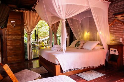 um quarto com uma cama de dossel em Villa Arumã Pousada em Alter do Chão