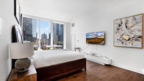 a bedroom with a bed and a large window at Lux 2 Bedroom 1 Bath Suite in Hudson Yards in New York