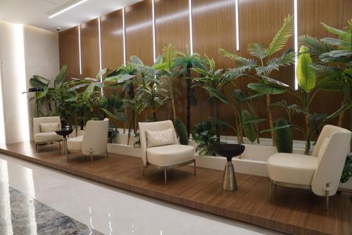 a waiting room with chairs and plants at Diamond 72 apartment , Skopje City - Center, Diamond Residences, free parking in Skopje