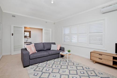 a living room with a couch and a table at Seaside on Swan - Nespresso Beach Wifi in Grange