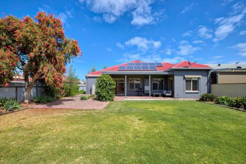 a house with solar panels on the roof at Seaside on Swan - Nespresso Beach Wifi in Grange