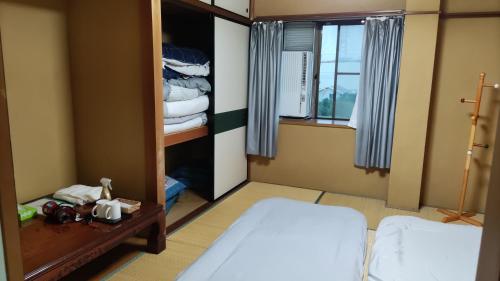 um quarto com uma cama e um closet em 古民家貸し切り0818変則あり最大10人まで em Gifu
