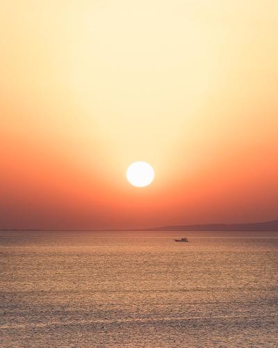 a boat in the ocean at sunset at Gravity Hotel & Aqua Park Hurghada Families and Couples Only in Hurghada