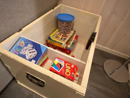 a drawer full of toys in a room at Riverfront house with 98 inch TV, ps5 & activities in Narvik
