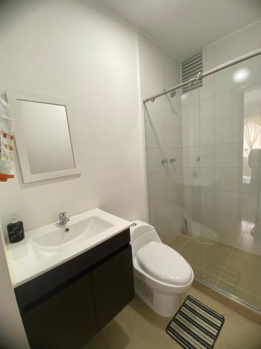 y baño con aseo, lavabo y ducha. en apartamento ubicado parte histórica de manizales, en Manizales