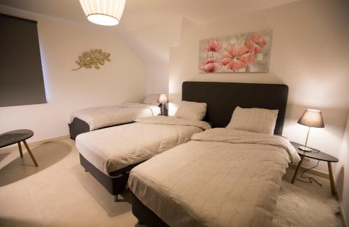 Postel nebo postele na pokoji v ubytování Villa&Loge