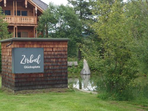 a building with a sign in front of a house at Premium Tauernstyle Golling in Mariapfarr