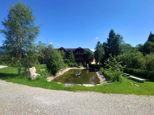 a pond in the yard of a house at Premium Tauernstyle Golling in Mariapfarr
