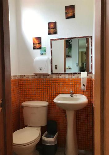 a bathroom with a toilet and a sink at Maytenus Galapagos in Puerto Ayora