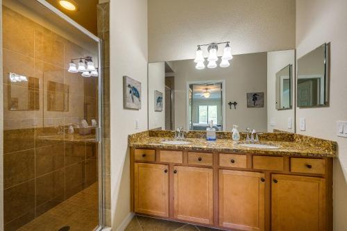 a bathroom with two sinks and a shower at Bonita Springs Condo Rental with 2 Screened Porches in Bonita Springs
