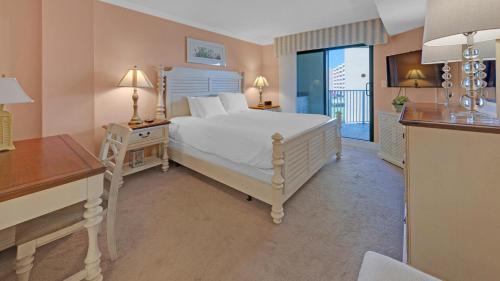 a bedroom with a bed and a desk with two lamps at Inlet Reef 215 - Spacious condo with complimentary seasonal beach service and great water views in Destin
