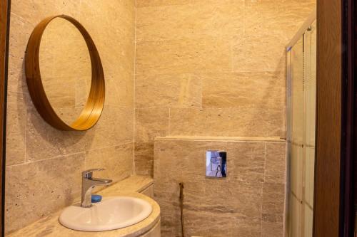 a bathroom with a sink and a mirror at The little Cottage Chalet- B3 in Amman