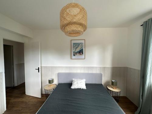 a bedroom with a large bed with two chairs at Le Plaisance, Beuil Les Launes in Beuil