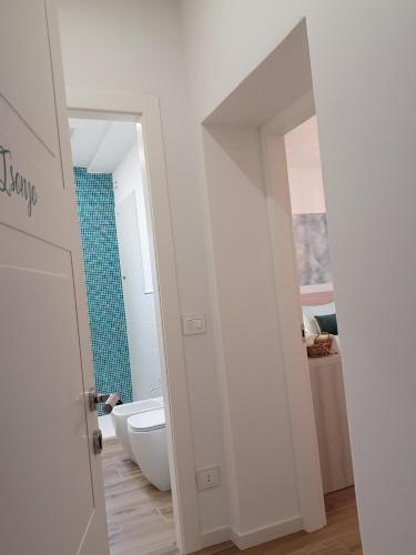 a bathroom with a tub and a toilet and a mirror at L'angolo di Luna in Gorizia