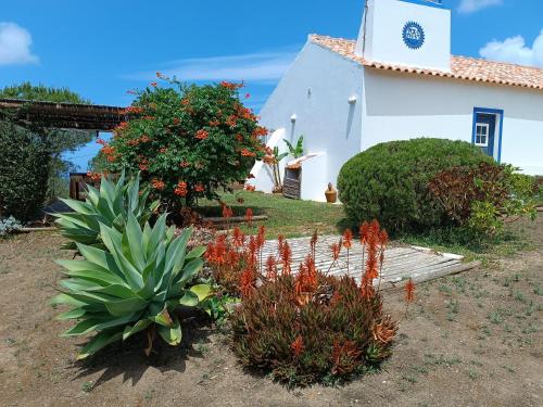 a small white church with plants in front of it at Monte Alentejano - Melides in Melides