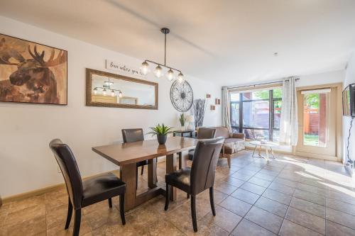 a dining room with a table and chairs at Resort Style Living with Private Lawn and Patio in Kelowna