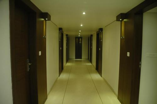 a long hallway with many elevators in a building at Hotel Kanan in Ahmedabad