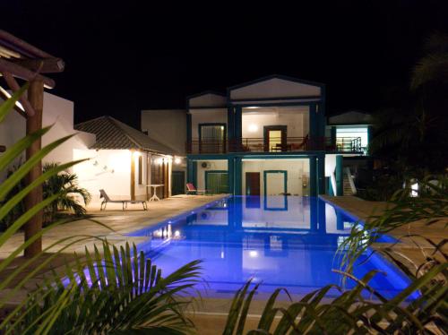 a swimming pool in front of a house at night at MelBliss Gostoso in São Miguel do Gostoso