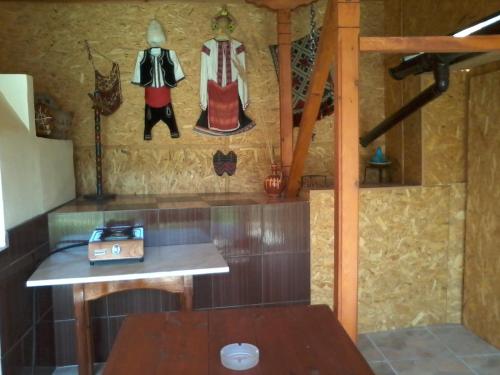 a room with a table and some clothes on the wall at Къща под наем PETROVA in Cherven
