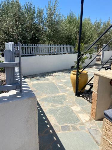 a patio with a white fence and a bench at Giasemi Aegina, Modern House in Áyioi Asómatoi