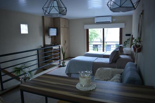 a living room with a couch and a bed and a table at Inti. in Saladillo